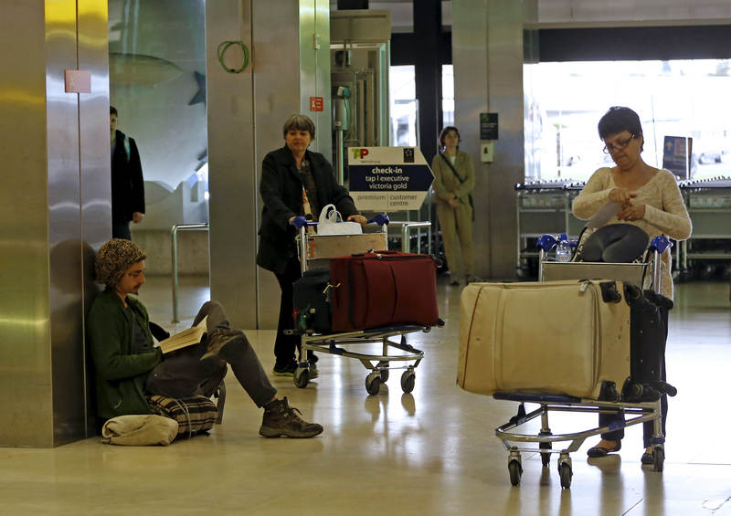 A passenger reads a book during a strike at Lisbon's airport May 2, 2015. u00e2u20acu201d Reuters pic