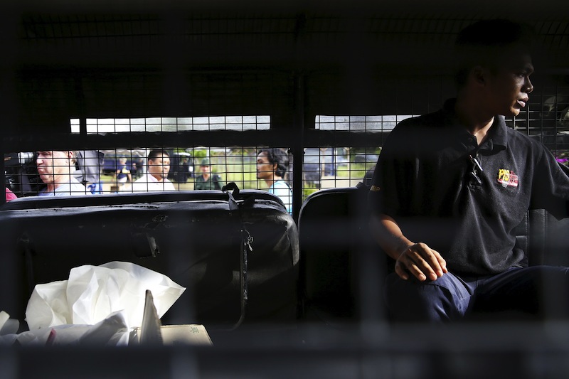 A forensic policeman transports body bags with human remains found at the site of human trafficking camps in the jungle close the Thailand border after bringing them to a police camp near Wang Kelian in northern Malaysia May 25, 2015.u00c2u00a0u00e2u20acu201d Reuters pic