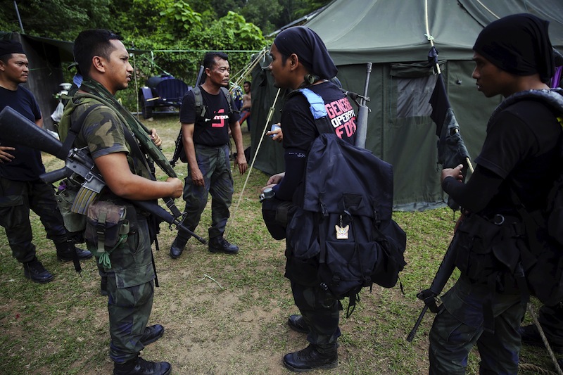 Members of special police force chat after returning to a police camp near Wang Kelian in northern Malaysia, close to the border with Thailand May 25, 2015. u00e2u20acu201d Reuters pic