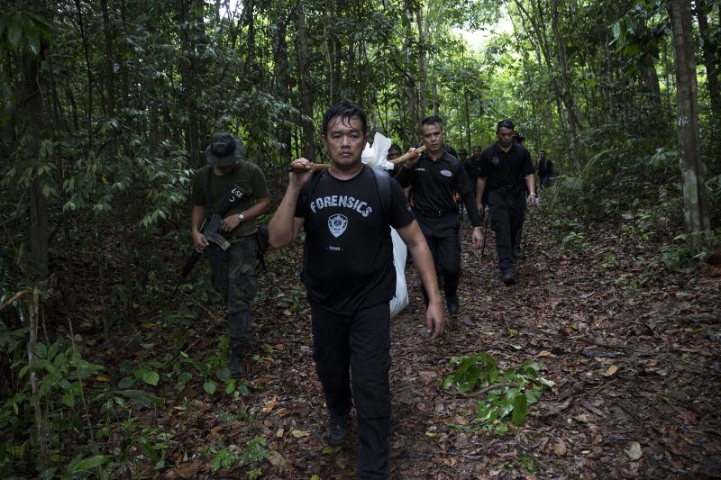 A police forensic team transport body bags with human remains at Bukit Wang Burma in northern Malaysia May 27, 2015. u00e2u20acu2022 Reuters pic