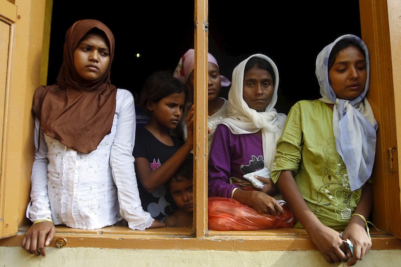 Migrants, believed to be Rohingya, look out the window of a shelter they are staying at since being rescued along with hundreds of others on Sunday from boats in Lhoksukon, Indonesia's Aceh Province May 12, 2015. u00e2u20acu201du00c2u00a0Reuters pic