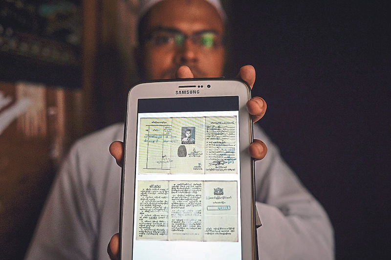 Junaid shows his original identification documents, which state in Burmese he is not a citizen of Myanmar because he is a Muslim. u00e2u20acu201d Pictures by Firdaus Latif