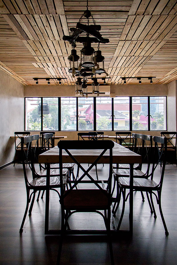 The spacious, wood-centric interior of Wicked Pancake Parlour is lit by natural sunlight.