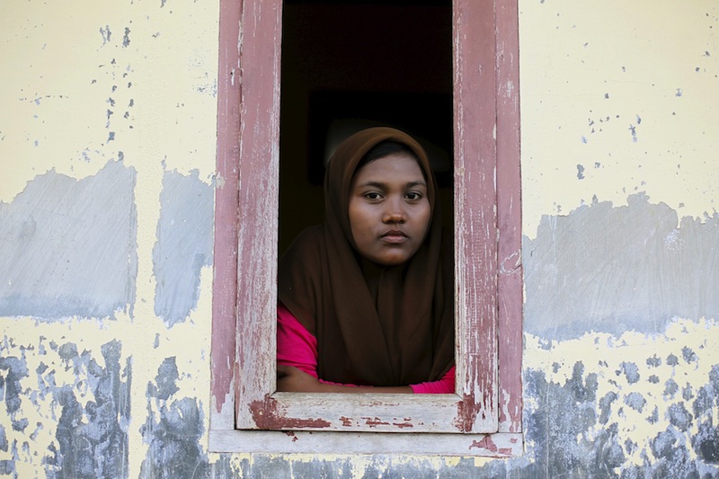 A Rohingya migrant woman, who arrived in Indonesia by boat, looks from a window of a shelter inside a temporary compound for refugees in Kuala Cangkoi village in Lhoksukon, Indonesia's Aceh Province, May 17, 2015. u00e2u20acu201d Reuters pic
