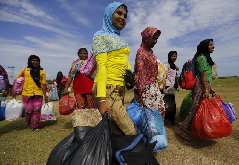 Rohingya migrant women, who arrived in Indonesia by boat, walks as they moves to better shelter inside a temporary compound for refugees in Kuala Cangkoi village in Lhoksukon, Indonesia's Aceh Province May 18, 2015. u00e2u20acu201du00c2u00a0Reuters pic