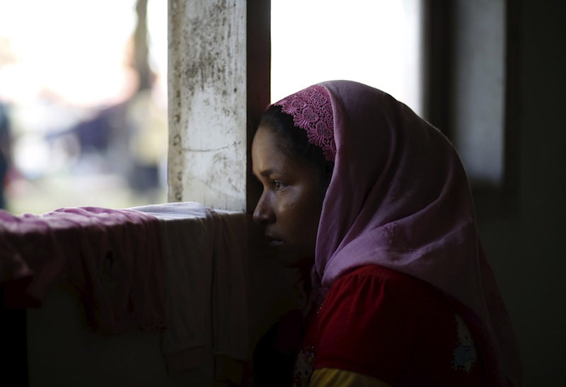 A Rohingya migrant who arrived in Indonesia this week by boat looks out the window of a  temporary shelter in Aceh Timur regency, near Langsa in Indonesia's Aceh Province May 24, 2015.u00c2u00a0u00e2u20acu201d Reuters pic