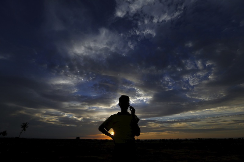 A Rohingya migrant, who arrived in Indonesia by boat, uses his handphone during sunset at a temporary compound for refugees in Kuala Cangkoi village in Lhoksukon, Indonesia's Aceh Province May 17, 2015. u00e2u20acu201d Reuters pic