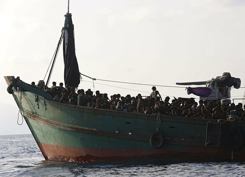 Migrants are seen aboard a boat tethered to a Thai navy vessel, in waters near Koh Lipe island, May 16, 2015. u00e2u20acu201d Reuters pic