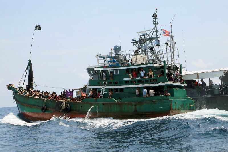 File picture shows a boat with migrants being towed away from Thailand by a Thai navy vessel, in waters near Koh Lipe Island, May 16, 2015. u00e2u20acu201d Reuters pic