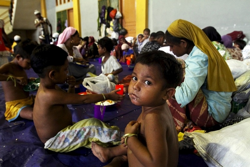 File picture shows a child, believed to be Rohingya, eating inside a shelter after he was rescued along with hundreds of others from boats in Lhoksukon, Indonesia's Aceh Province May 12, 2015. — Reuters pic