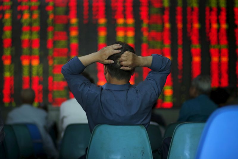 An investor looks at information displayed on an electronic screen at a brokerage house in Shanghai May 12, 2015. The Shanghai Composite Index is up 2.6 per cent today (May 19, 2015). u00e2u20acu201d Reuters pic