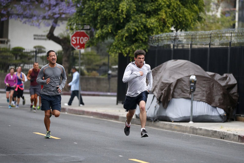 Runners from the Midnight Mission Running Club Phil Peng and Seth Becker run through Skid Row in Los Angeles April 20, 2015. — Reuters pic