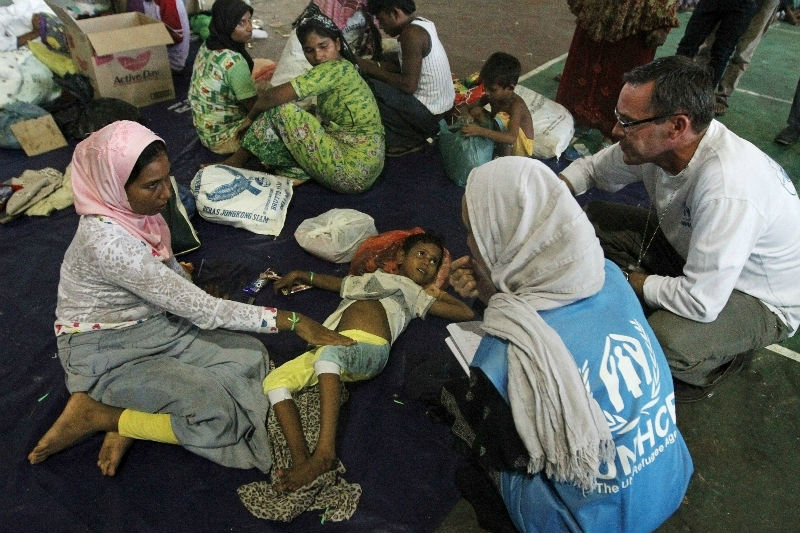 Staff from the UN refugee agency UNHCR talk to migrants, believed to be Rohingya, inside a shelter after they were rescued from boats in Lhoksukon, Indonesia's Aceh Province May 12, 2015. u00e2u20acu201d Reuters pic