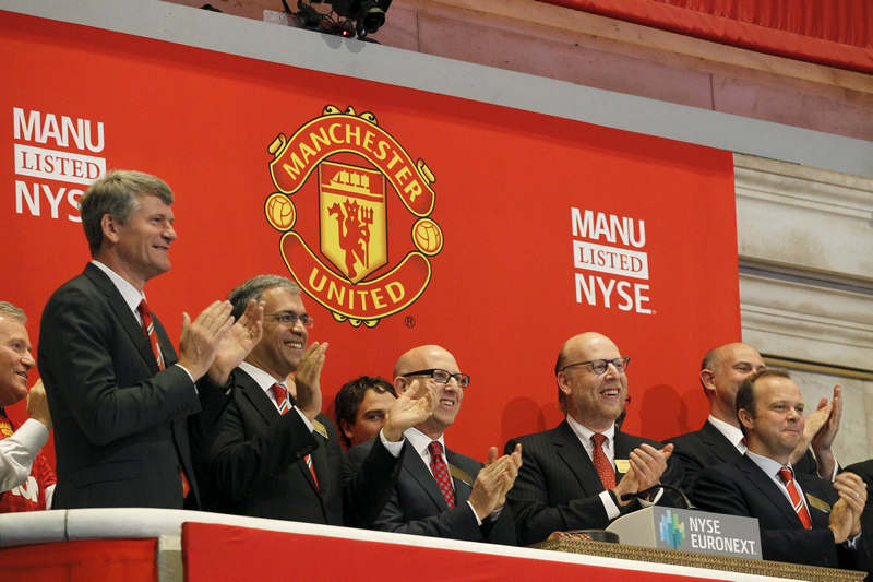 Executives and owners Joel (third left) and Avram Glazer (second left) celebrate Manchester United Ltd's initial public offering in the New York Stock Exchange August 10, 2012. u00e2u20acu201d Reuters pic