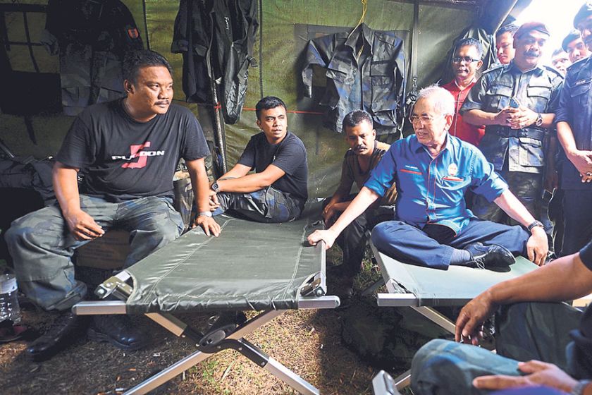 Wan Junaidi meets members of the General Operations Force at their tactical base in Wang Kelian. u00e2u20acu201d Picture by Ainuddin Ghazali