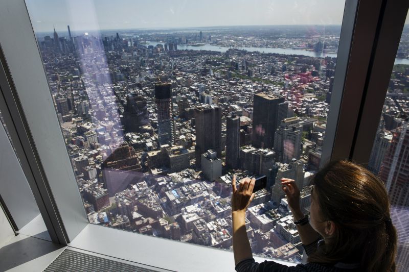 A woman looks out the windows of the newly opened One World Observatory in New York May 29, 2015. u00e2u20acu2022 Reuters pic