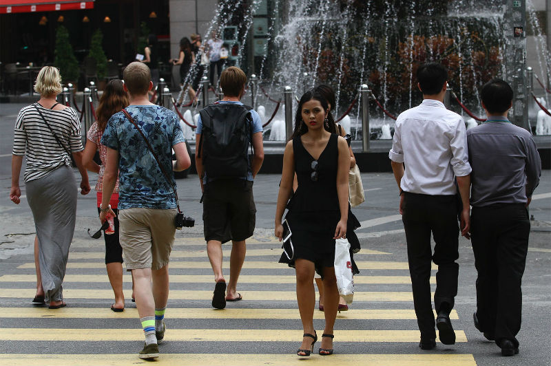People walk across a pedestrian crossing in front of a shopping mall at Kuala Lumpur's Golden Triangle, as seen in 2015. — Picture by Yusof Mat Isa