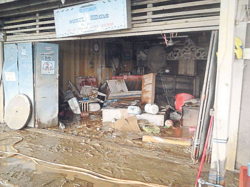 Nurhidayah’s shop was knee-deep in mud after the floods.