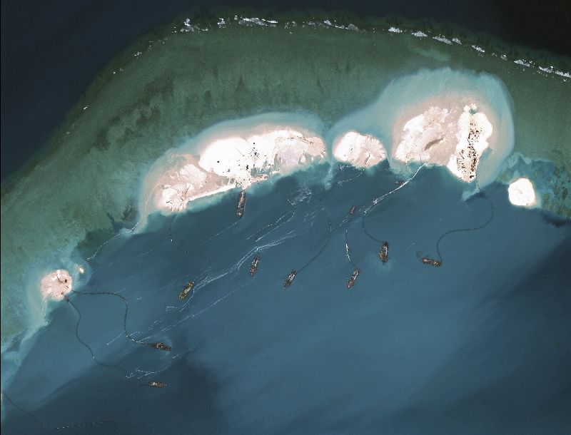 A handout satellite image shows dredgers working at the northernmost reclamation site of Mischief Reef, part of the Spratly Islands, in the South China Sea, March 16, 2015. NYT 