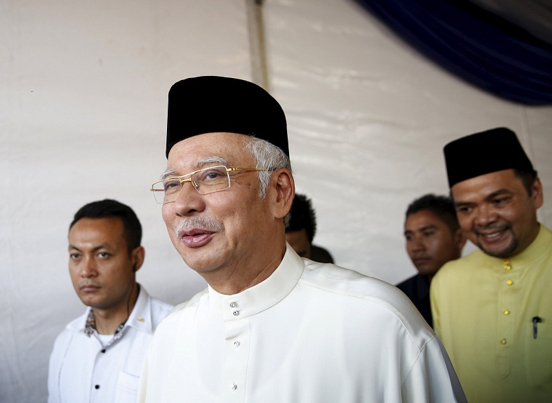 Malaysiau00e2u20acu2122s Prime Minister Najib Razak walks (centre) after speaking to the media at a mosque outside Kuala Lumpur, Malaysia, July 5, 2015. u00e2u20acu201d Reuters pic