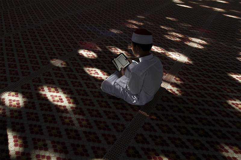 A young Muslim boy recites the Quran during the holy month of Ramadan at the National Mosque in Kuala Lumpur, July 7, 2015. u00e2u20acu201d Picture by Yusof Mat Isan