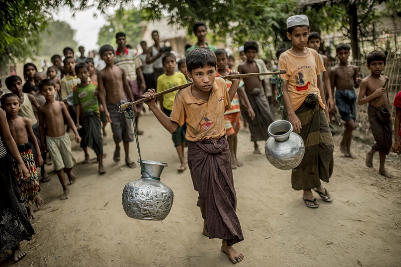 Jubair, 13, fetches water for the family he lives with in the Rohingya village of Thayet Oak, Myanmar, June 2, 2015. u00e2u20acu201d Picture by Tomas Munita for The New York Times