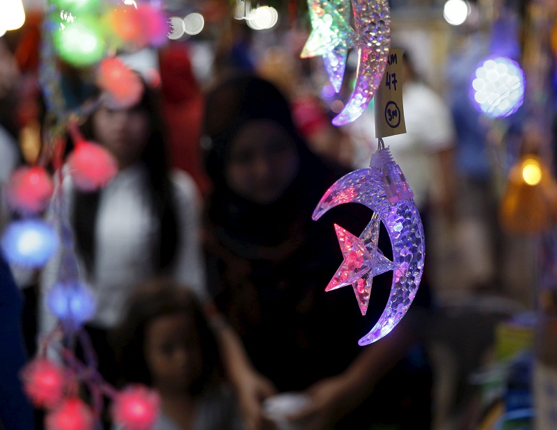 People look at light decorations at the Ramadan bazaar ahead of the Hari Raya Aidilfitri celebrations in Kuala Lumpur, July 14, 2015. u00e2u20acu201d Reuters pic