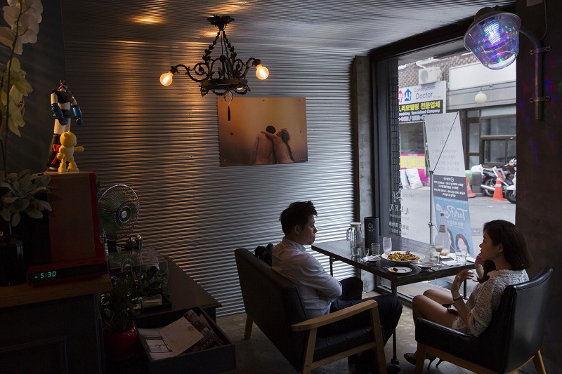 Customers chat and drink in Aoi Sora in the Itaewon neighbourhood of Seoul, South Korea, July 9, 2015.