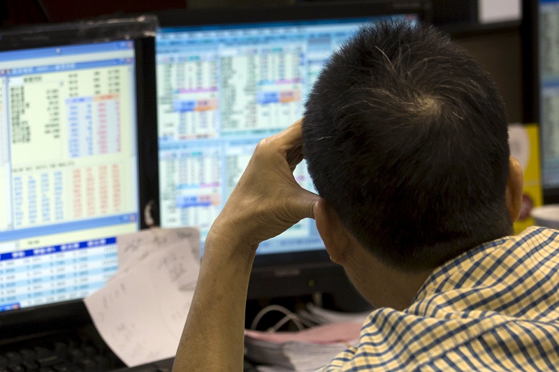 An investor monitors share prices inside a brokerage firm during morning trading in Hong Kong, July 8, 2015. u00e2u20acu201d Reuters pic