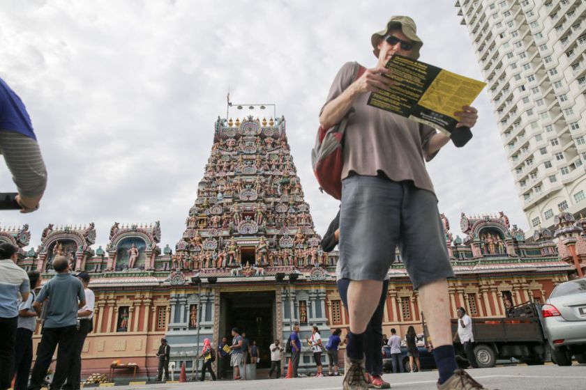 That morning, you could tell who was on the walk... by the map they were holding! The spectacular Sri Kandaswamy Temple is in the background.