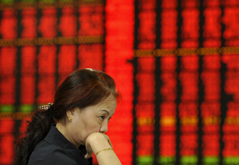 An investor is seen in front of an electronic board showing stock information at a brokerage house in Fuyang, Anhui, China. China froze IPOs on July 4, 2015 and set up a market-stabilisation fund after its share markets nose-dived. u00e2u20acu201d Reuters pic