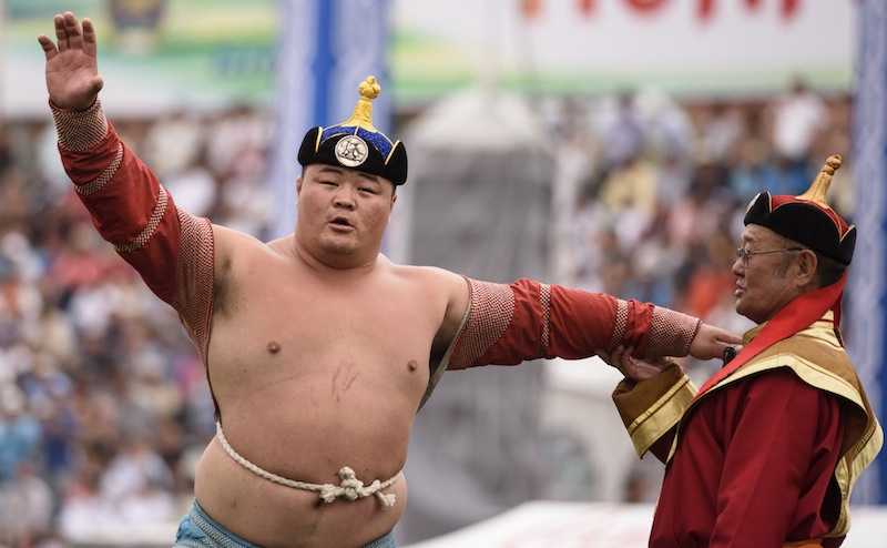This picture taken on July 12, 2015 shows Mongolian wrestler Enkhtuvshingiin Oyunbold performing the eagle dance during the National Naadam Festival at the Central Stadium in Ulan Bator. u00e2u20acu201d AFP pic