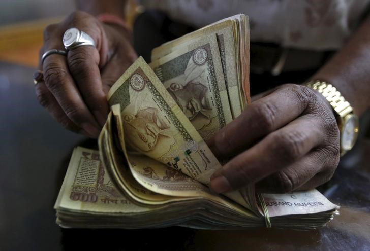 A money lender counts Indian rupee currency notes at his shop in Ahmedabad, India, May 6, 2015.u00c2u00a0u00e2u20acu201d Reuters pic