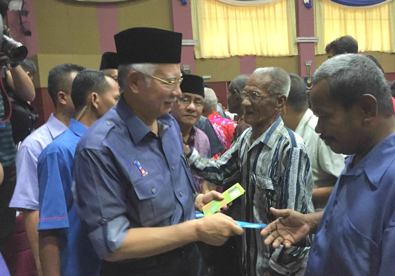 Prime Minister Datuk Seri Najib Razak (left) distributing tithe contributions in his constituency in Pekan, Pahang, July 12, 2015. u00e2u20acu201d Picture by Kamles Kumar  