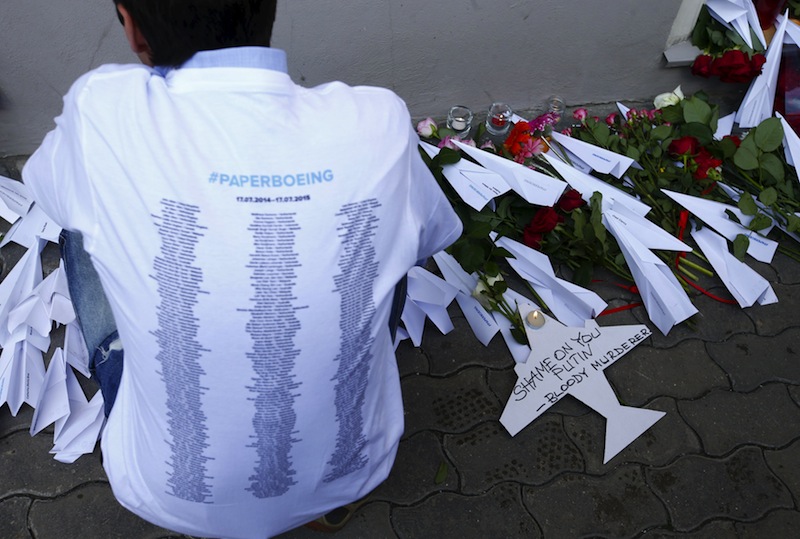 A visitor wears a t-shirt displaying names of the victims of the Malaysia Airlines flight MH17 plane crash during a commemoration ceremony outside the Dutch embassy in Moscow, Russia, July 17, 2015.u00c2u00a0u00e2u20acu201d Reuters pic