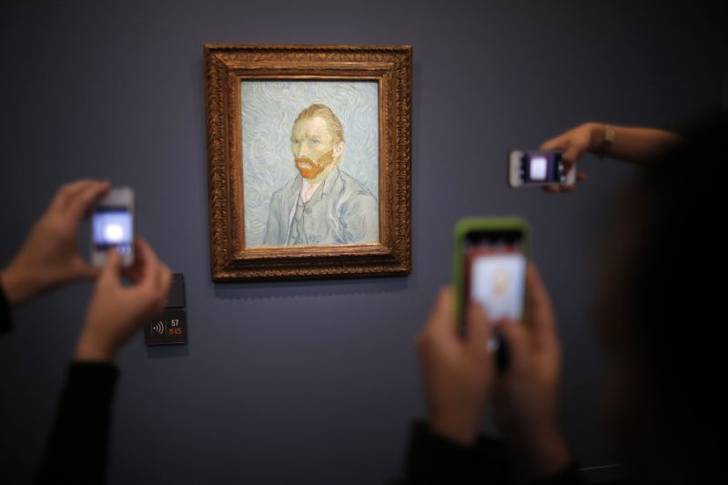 Visitors take pictures with their mobile phone of the painting u00e2u20acu02dcPortrait de lu00e2u20acu2122Artiste, 1889u00e2u20acu2122 (Self-Portrait) by artist Vincent van Gogh (1853-1890) at the Musee du00e2u20acu2122Orsay in Paris, France, July 29, 2015. u00e2u20acu201d Reuters pic