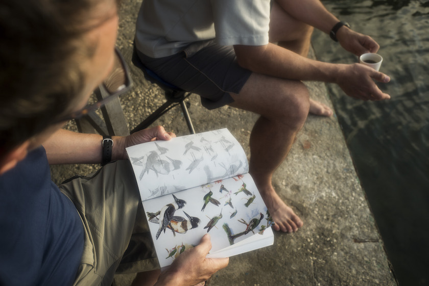Dan Whittle, left, a lawyer with the Environmental Defence Fund, and Jake Kritzer, a scientist with the organisation, look through a bird guide at a research station in the Jardines de la Reina, a protected area in Cuba July 14, 2015. — Picture by Todd Heisler/The New York Times