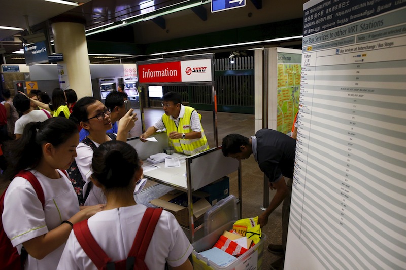Train operation staff assist affected commuters at a North-South line train station after train services were disrupted during evening rush hour in Singapore, July 7, 2015.u00c2u00a0u00e2u20acu201d Reuters pic