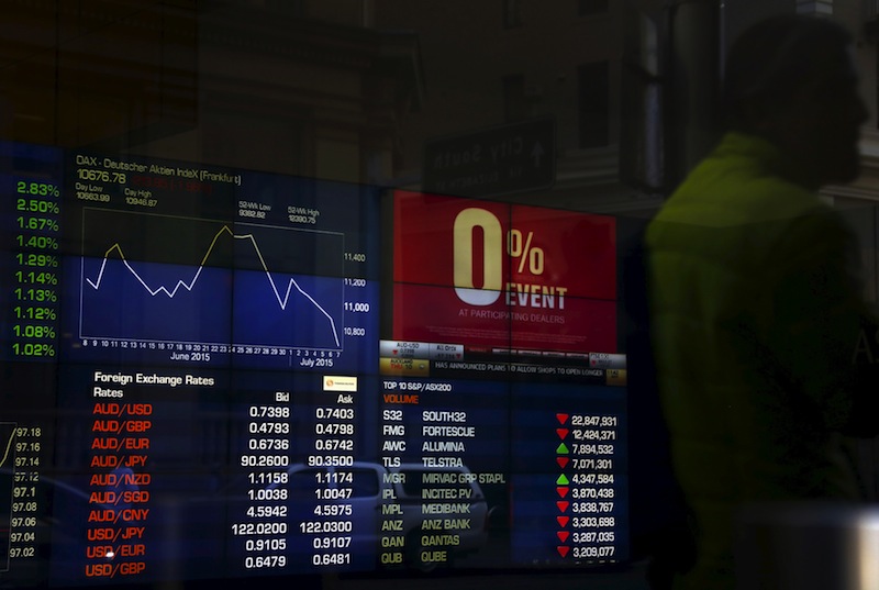 An investor is reflected in a window as he looks at boards displaying stock prices and an advertisement for zero percent interest rate for purchasing a car at the Australian Securities Exchange in central Sydney, Australia, July 8, 2015. u00e2u20acu201du00c2u00a0Reuters pic