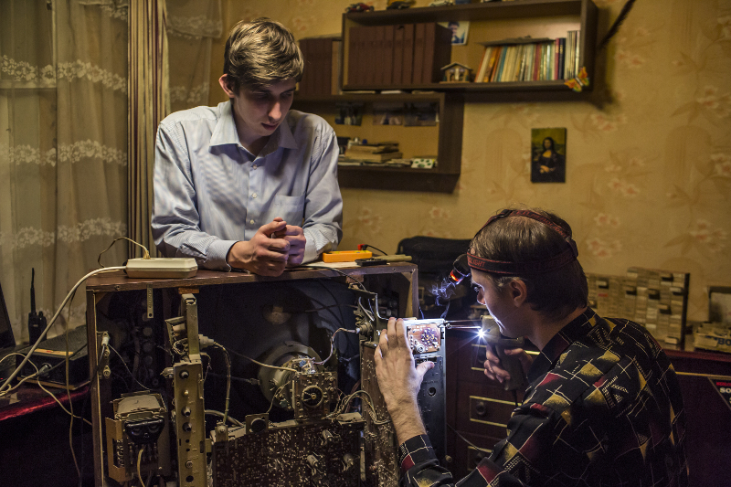 Pavel Pavlov, left, and Aleksandr Kryukov, known on YouTube as the do-it-yourself science duo Kreosan, repair an old Soviet television in Luhansk, Ukraine, March 15, 2015. — Pictures by Brendan Hoffman/The New York Times