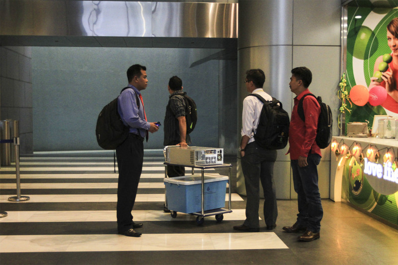 Officers from the special task force remove a CPU and a box from the 1Malaysia Development Berhad's office at Menara IMC in Kuala Lumpur, July 8, 2015. u00e2u20acu201d Picture by Yusof Mat Isa