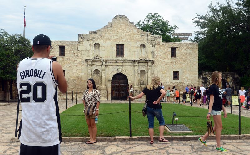 Tourists pose at the Alamo fort in Texas. u00e2u20acu201d AFP pic