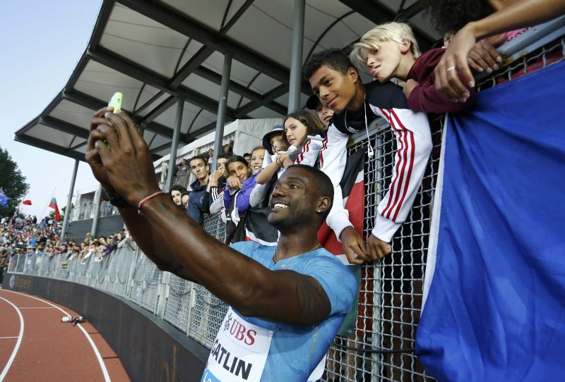 Justin Gatlin of the US takes a selfie with fans after winning the 100 metres at the IAAF Diamond League Athletissima athletics meeting, Pontaise Stadium, Lausanne, Switzerland, July 9, 2015. REUTERS/Pierre Albouy