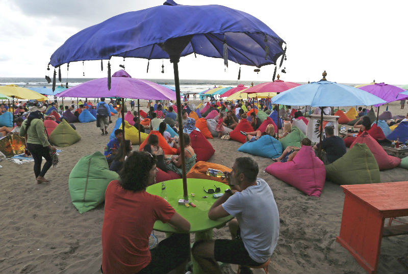 A tourist drinks a bottle of beer during sunset at Seminyak beach, near Kuta, on the resort island of Bali, March 3, 2015. u00e2u20acu201d Reuters pic