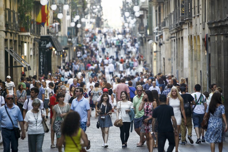 People stroll down the Ferran Street at the city-centre of Barcelona June 28, 2015. u00e2u20acu201d AFP pic