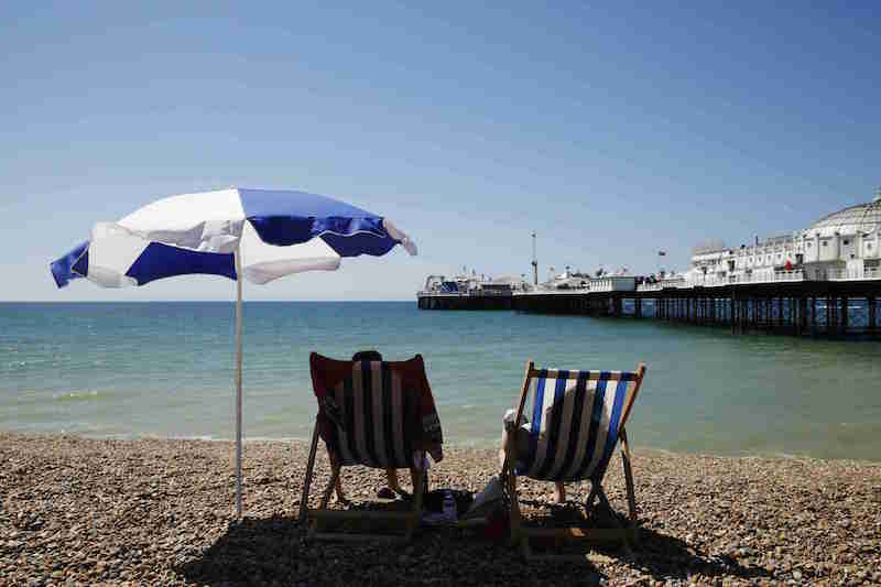 People sit in deck chairs on a hot summer day at Brighton beach in Britain June 30, 2015. u00e2u20acu201d Reuters pic