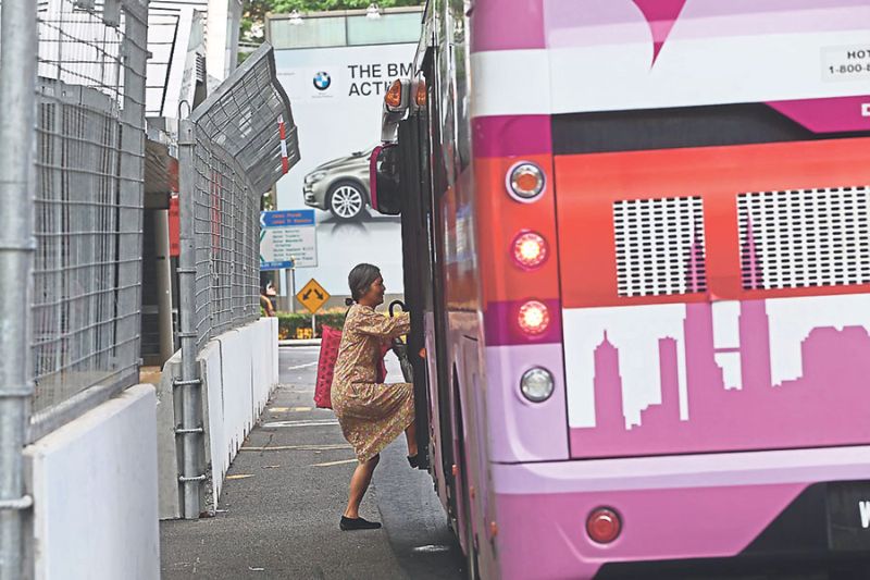 The barricades have forced passengers to board buses on the road instead of bus stops, as can be seen with this woman at Jalan P. Ramlee. u00e2u20acu2022 Malay Mail pic