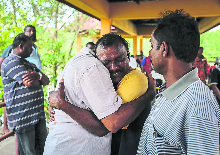 Gnanasegaran being consoled by family members at the Tanjung Karang jetty.
