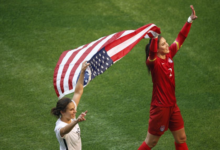 United States midfielder Carli Lloyd (10) and United States goalkeeper Hope Solo (1) celebrate with an American flag after defeating Japan in the final of the FIFA 2015 Women's World Cup at BC Place Stadium, Vancouver. United States won 5-2. u00e2u20acu201d Reuters p