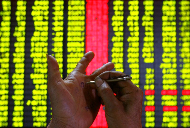 An investor makes a note on his hand at a stock exchange in Kunming, capital of China's Yunnan province July 5, 2007. u00e2u20acu201d Reuters pic
